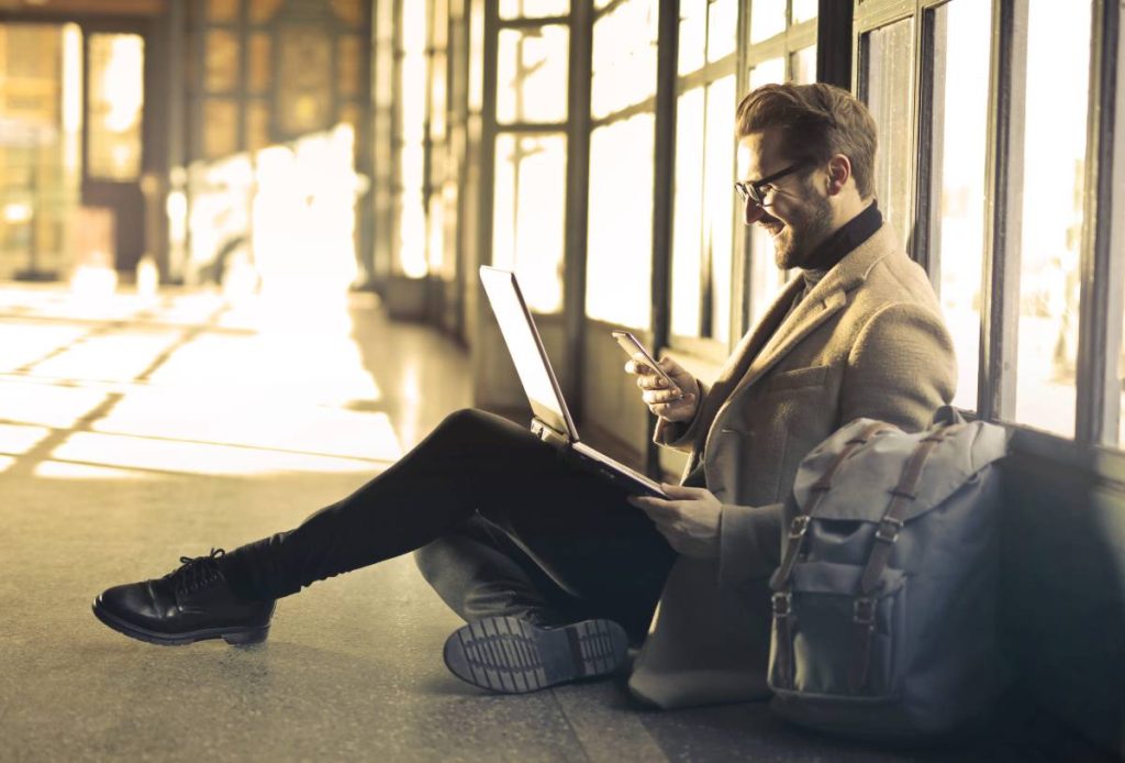 man sitting on floor with laptop